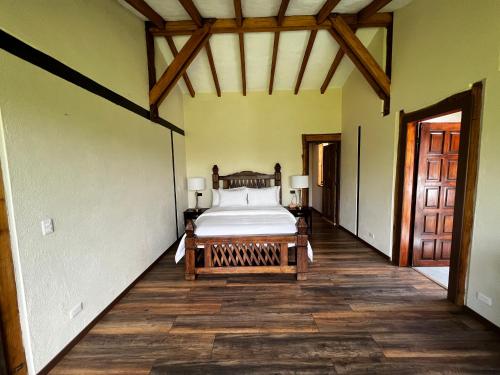a bedroom with a bed in the middle of a room at Hacienda Jimenita Wildlife Reserve in Puembo