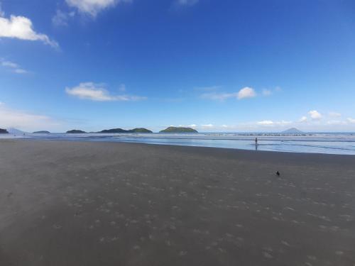 a beach with a bird sitting on the sand at Pousada Rosa dos Ventos Juquehy in Juquei