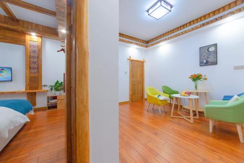 a room with a bed and a table and chairs at Easy House in Zhangjiajie