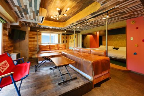 a bedroom with a bed and a desk and chairs at Lions Mansion Sapporo Jozankei Sanbankan - Vacation STAY 10916 in Jozankei
