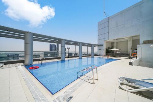 a large swimming pool on top of a building at Studio close to Burj Khalifa and Downtown Dubai in Dubai