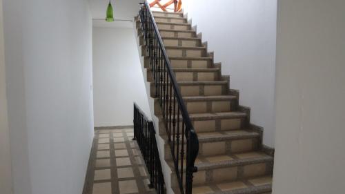 a staircase in a building with a person walking up it at Hotel Sol y Playa Montañita in Montañita