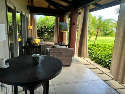 a table in a living room with a couch at Kehena Beach guesthouse in Pahoa