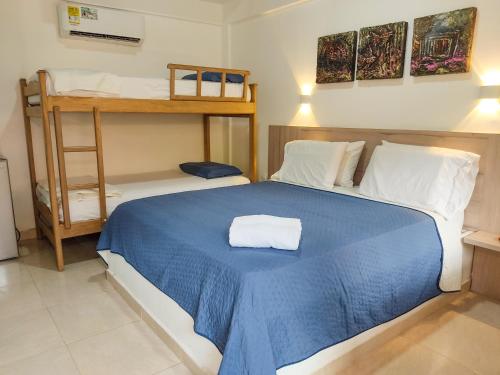 a bedroom with a blue bed and a bunk bed at Senderos del Mar - Tayrona in Buritaca