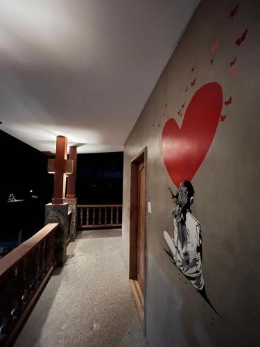 a painting of a woman on a wall with a heart at Tabularasa - T Palawan in San Vicente