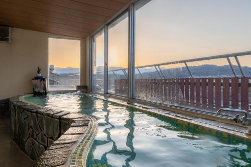 a swimming pool on the balcony of a building at Yumotoya in Matsumoto