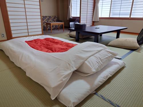 a large white bed sitting in a living room at Yumotoya in Matsumoto
