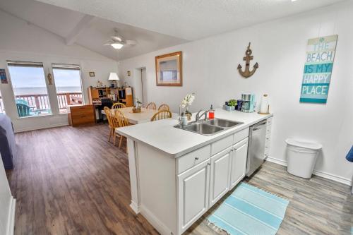 a kitchen with a sink and a table in a room at Amazing Oceanfront 2BR Home Cozy Peaceful and Kid and Pet Friendly in Freeport