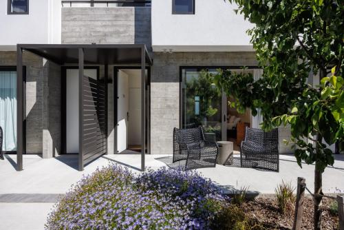 a group of chairs sitting on a patio at The Village Apartments at NZCIS in Upper Hutt