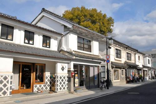 a street with white buildings on a city street at Yumotoya in Matsumoto