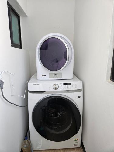 a microwave sitting on top of a washing machine at Gyeongju happy house in Gyeongju