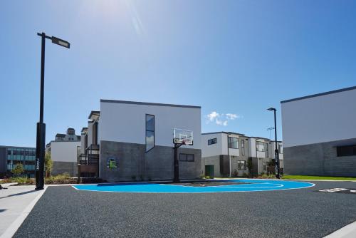 a basketball court in front of a building at Village Apartments at NZCIS in Upper Hutt