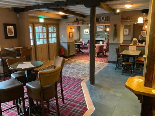 a restaurant with tables and chairs in a room at The Sun Inn in Windermere