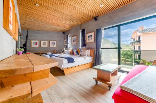 a bedroom with a bed and a large window at Harajuku lnn in Eluan