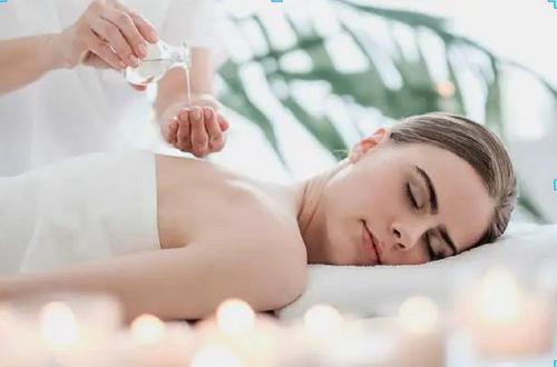 a woman laying in a bathtub getting a massage at Serenity House Pemberton Cottage & Wellness Spa in Pemberton