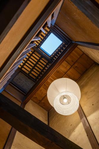 an overhead view of a ceiling with a light and a window at Machiya Hotel YANAGI in Kyoto