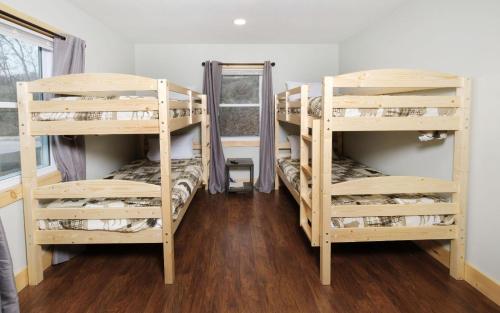a room with three bunk beds and a window at Big Oak Hideaway in Gatlinburg