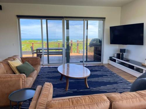 a living room with a couch and a coffee table at Martyrs Lookout - Luxury Accommodation in Peterborough