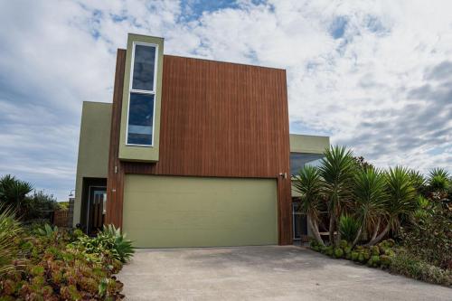 a house with a large garage door in front of it at Martyrs Lookout - Luxury Accommodation in Peterborough