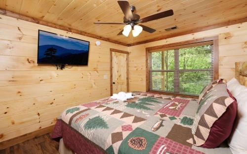 a bedroom with a bed and a ceiling fan at Wine Not in Gatlinburg