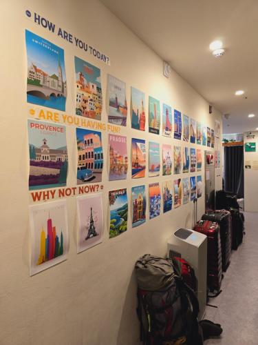a wall with pictures and posters on it at Seoul Cube Jongro in Seoul