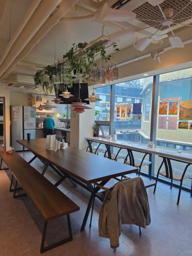 a room with tables and benches in a restaurant at Seoul Cube Jongro in Seoul
