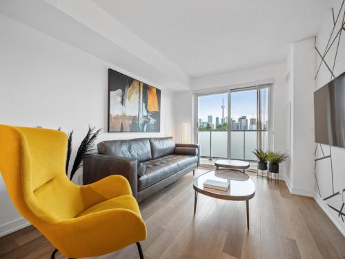 a living room with a couch and a table at Sleek 1BR & office Condo - CN Tower, Skyline view in Toronto