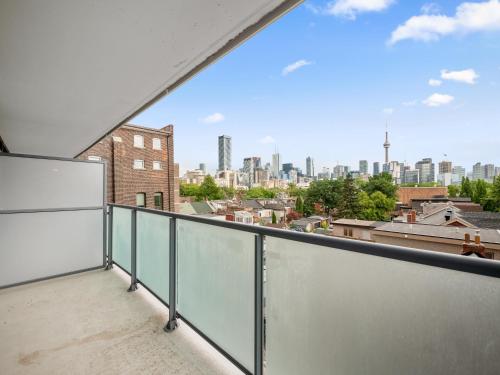 a balcony with a view of the city at Sleek 1BR & office Condo - CN Tower, Skyline view in Toronto