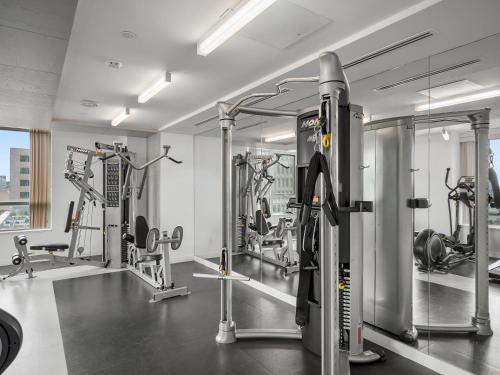 a gym with several treadmills and machines at Sleek 1BR & office Condo - CN Tower, Skyline view in Toronto