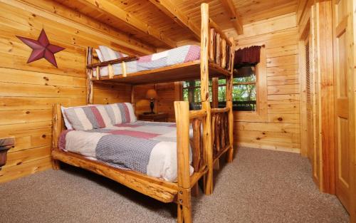 a bedroom with two bunk beds in a log cabin at American Eagle in Sevierville