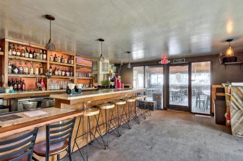 a bar in a restaurant with bar stools at Hotel Becket, BW Signature Collection in South Lake Tahoe