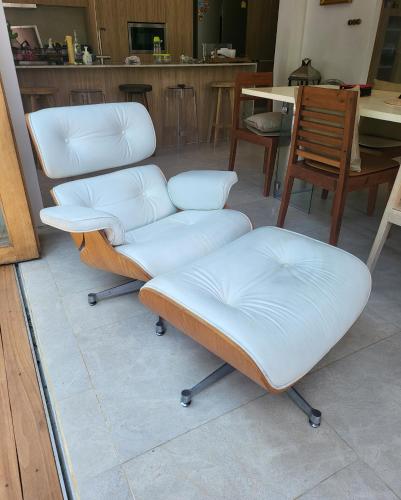 three chairs with white cushions sitting in a room at The Hip House Villa Phuket in Ban Bang Khu