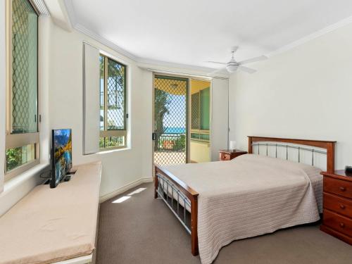 a bedroom with a bed and two windows at Casa del Rey 1 in Gold Coast