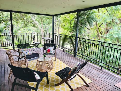 a screened in porch with chairs and a table at Hawkesbury Wisemans Ferry - Private riverside oasis in Wisemans Ferry