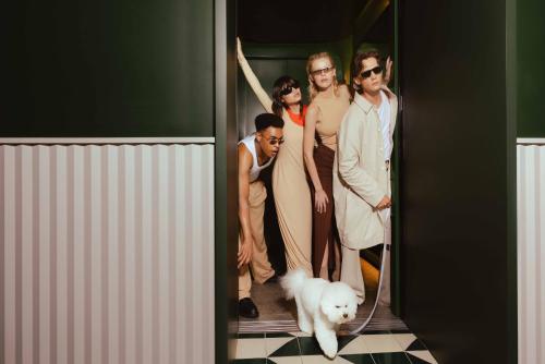 a group of people standing in a doorway with a dog at The Standard, Bangkok Mahanakhon in Bangkok