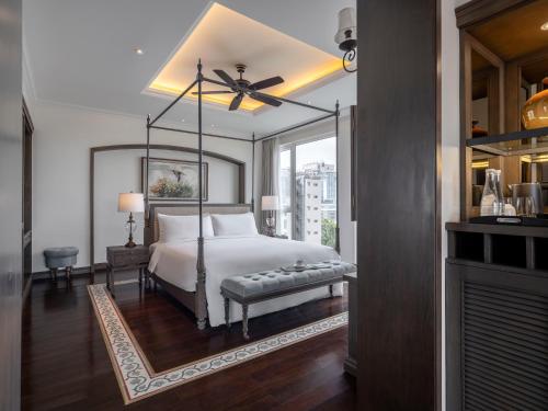 a bedroom with a bed and a ceiling fan at De Syloia Hotel in Hanoi