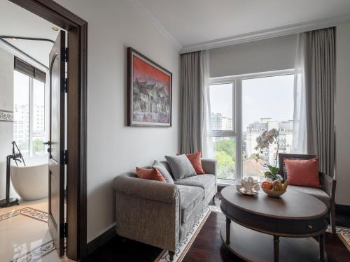 a living room with a couch and a table at De Syloia Hotel in Hanoi