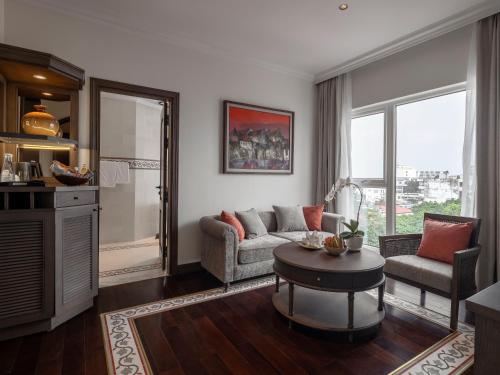 a living room with a couch and a table at De Syloia Hotel in Hanoi