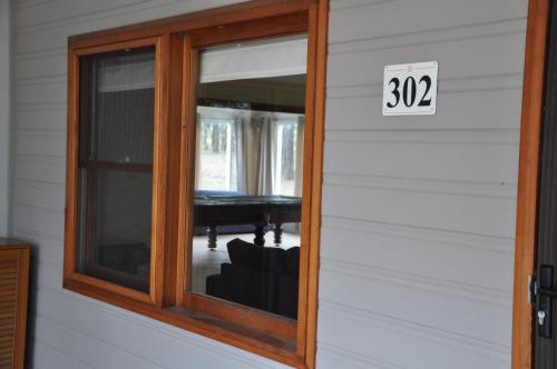 a house with a window with sign on it at Pokolbin Village Estate in Pokolbin