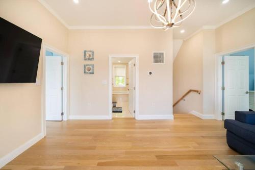a living room with a couch and a flat screen tv at 40 - 4BR Lakeview - Lakeside retreat near GJK View in Yarmouth