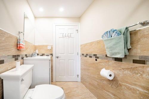 a bathroom with a white toilet and a sink at 40 - 4BR Lakeview - Lakeside retreat near GJK View in Yarmouth