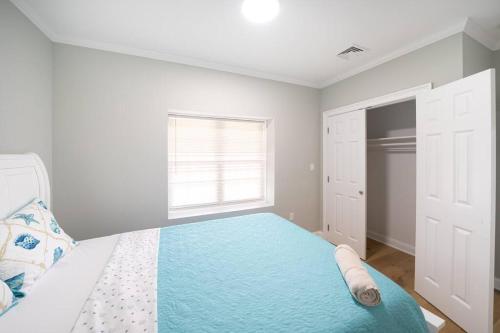 a white bedroom with a bed with a blue blanket at 40 - 4BR Lakeview - Lakeside retreat near GJK View in Yarmouth