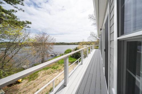 a balcony with a view of the water at 40 - 4BR Lakeview - Lakeside retreat near GJK View in Yarmouth