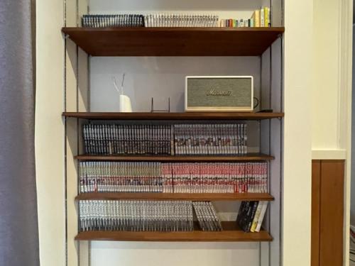 a book shelf filled with lots of dvds at Mt Fuji view! Cottage JOKIGEN House F in Yamanakako