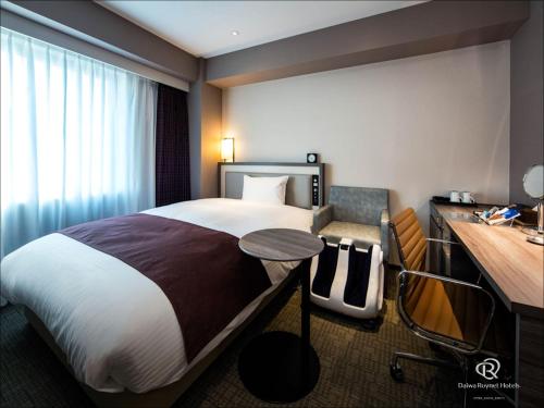 a hotel room with a bed and a desk at Daiwa Roynet Hotel Chiba Ekimae in Chiba