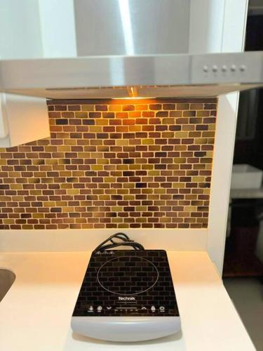 a black remote control sitting on top of a stove at Azure North Beach View New Unit Rustic Suite in Lagundi
