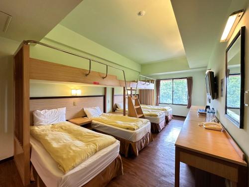 Postel nebo postele na pokoji v ubytování CHIENTAN Youth Hotel