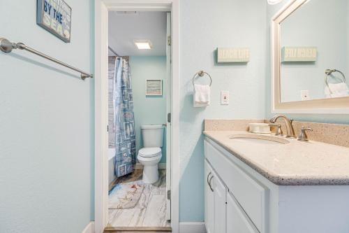 a bathroom with a sink and a toilet at Bayfront Kontiki in Rockport