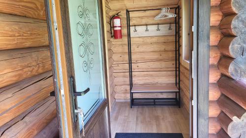 - un petit sauna avec un banc et un extincteur dans l'établissement Котеджі Карпати Fest, à Mijgiria