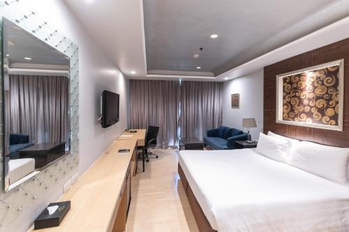 a hotel room with a bed and a television at Admiral Premier Bangkok in Bangkok
